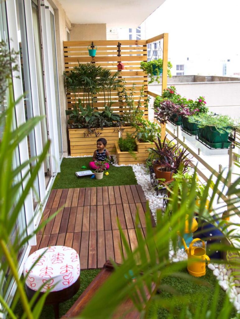 An image of a child sitting on a balcony garden full of greenery and houseplants.